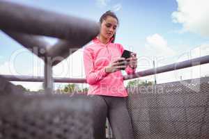 Woman using mobile phone in the balcony