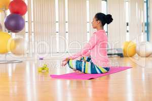 Woman performing yoga in the gym
