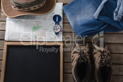 Apparels and travelling accessories on wooden plank