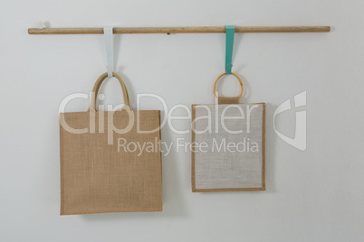 Two bags hanging on wooden rod