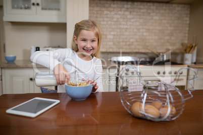 Young girl having breakfast in the kitchen at home