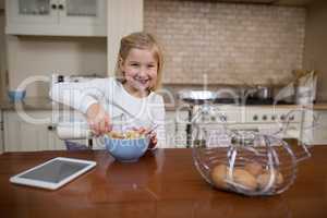 Young girl having breakfast in the kitchen at home