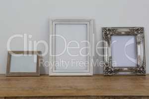 Frames arranged on wooden table