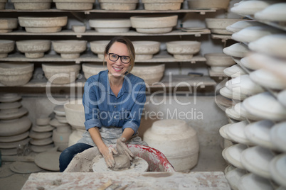 Portrait of female potter molding a clay