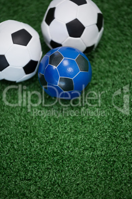 Footballs on artificial grass