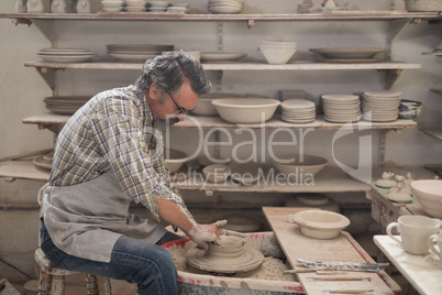 Male potter molding a clay