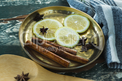 Various spices, spoon and napkin on wooden table