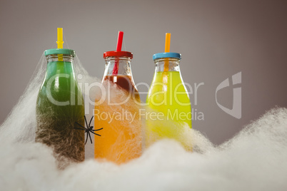 Close up of cotton candy by colorful drinks and spider
