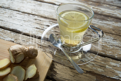 High angle view of fresh ginger tea by cutting board on table