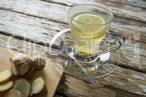 High angle view of fresh ginger tea by cutting board on table