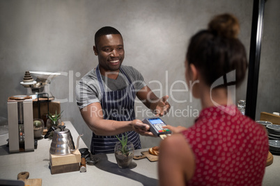 Customer making payment through credit card at counter