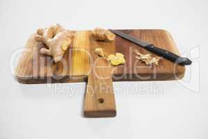 High angle view of ginger and knife on cutting board