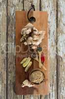 Overhead view of spices on serving board over weathered table
