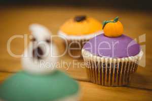 Close up of cup cake with pumpkin during Halloween