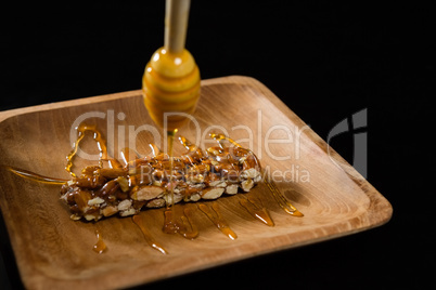 Honey being poured into granola bar