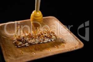 Honey being poured into granola bar