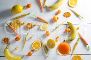 Overhead view of various fruits with juice glass