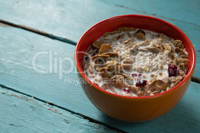 Breakfast cereal in bowl on wooden table