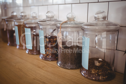 Close up of various food in glass jars with labels at coffee shop