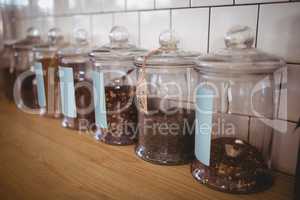 Close up of various food in glass jars with labels at coffee shop