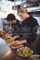 Young female chefs preparing fresh food at kitchen counter