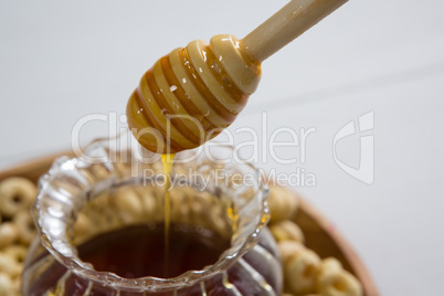 Honey pouring into a cereal bowl