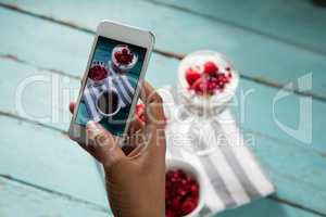 Hands taking photo of breakfast with mobile phone