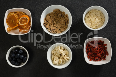 Bowl of dried orange slices, blueberries and breakfast cereals