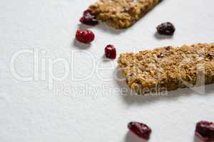 Granola bar with berries on white background