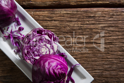 Red cabbage in tray on wooden table