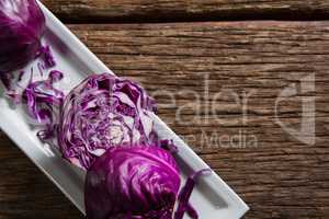 Red cabbage in tray on wooden table