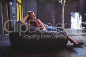 Young female customer relaxing on bean bag