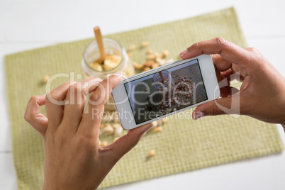 Hands taking photo of breakfast with mobile phone