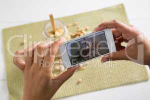 Hands taking photo of breakfast with mobile phone