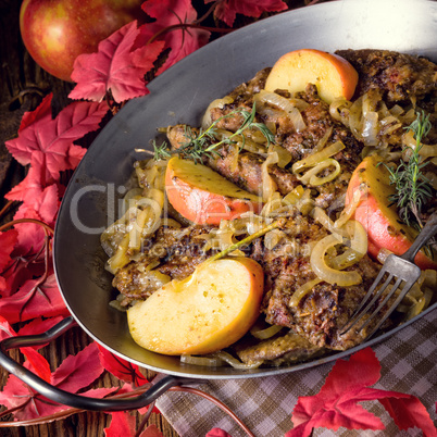 Fried liver with onion apple and herbs.