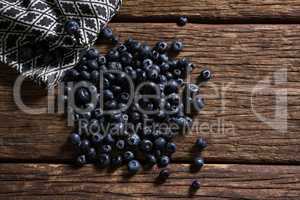 Blueberries and napkin on wooden table