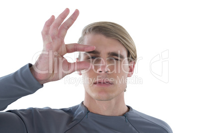Portrait of businessman winking eye while holding invisible eyeglasses