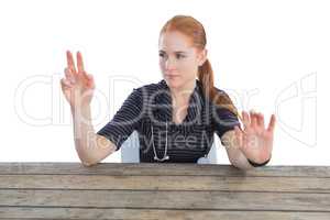 Female doctor touching invisible screen at table