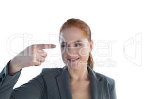 Smiling businesswoman looking at index finger