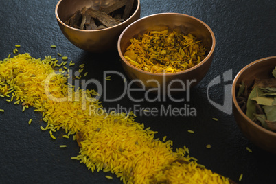 Various spices in bowl with yellow rice