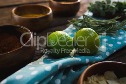 Lime fruit with herbs on wooden table