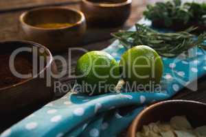 Lime fruit with herbs on wooden table