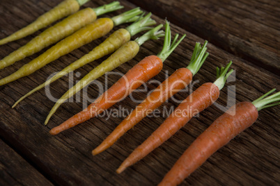 Carrots arranged on wooden table