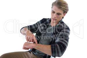 Young businessman looking at imaginary wristwatch