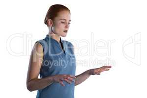 Young businesswoman working on imaginary screen
