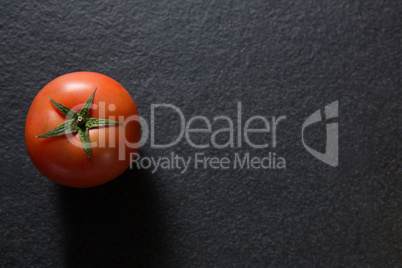 Tomato on black background