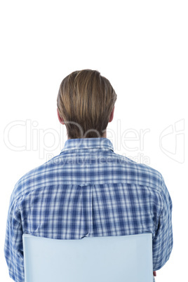 Rear view of businessman with brown hair sitting on chair