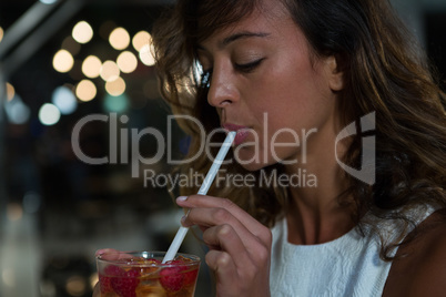 Close-up of beautiful woman having drink