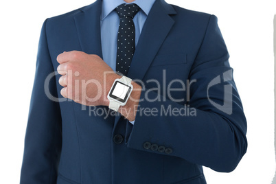 Mid section of businessman showing smart watch