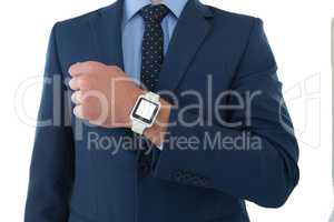 Mid section of businessman showing smart watch